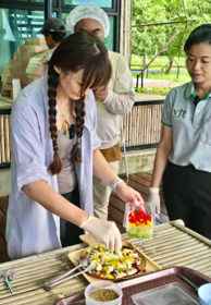 Participant preparing food during the organic farm workshop