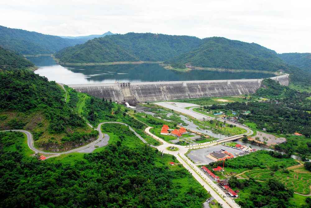 Khun Dan Prakan Chon Dam amid forested mountains
