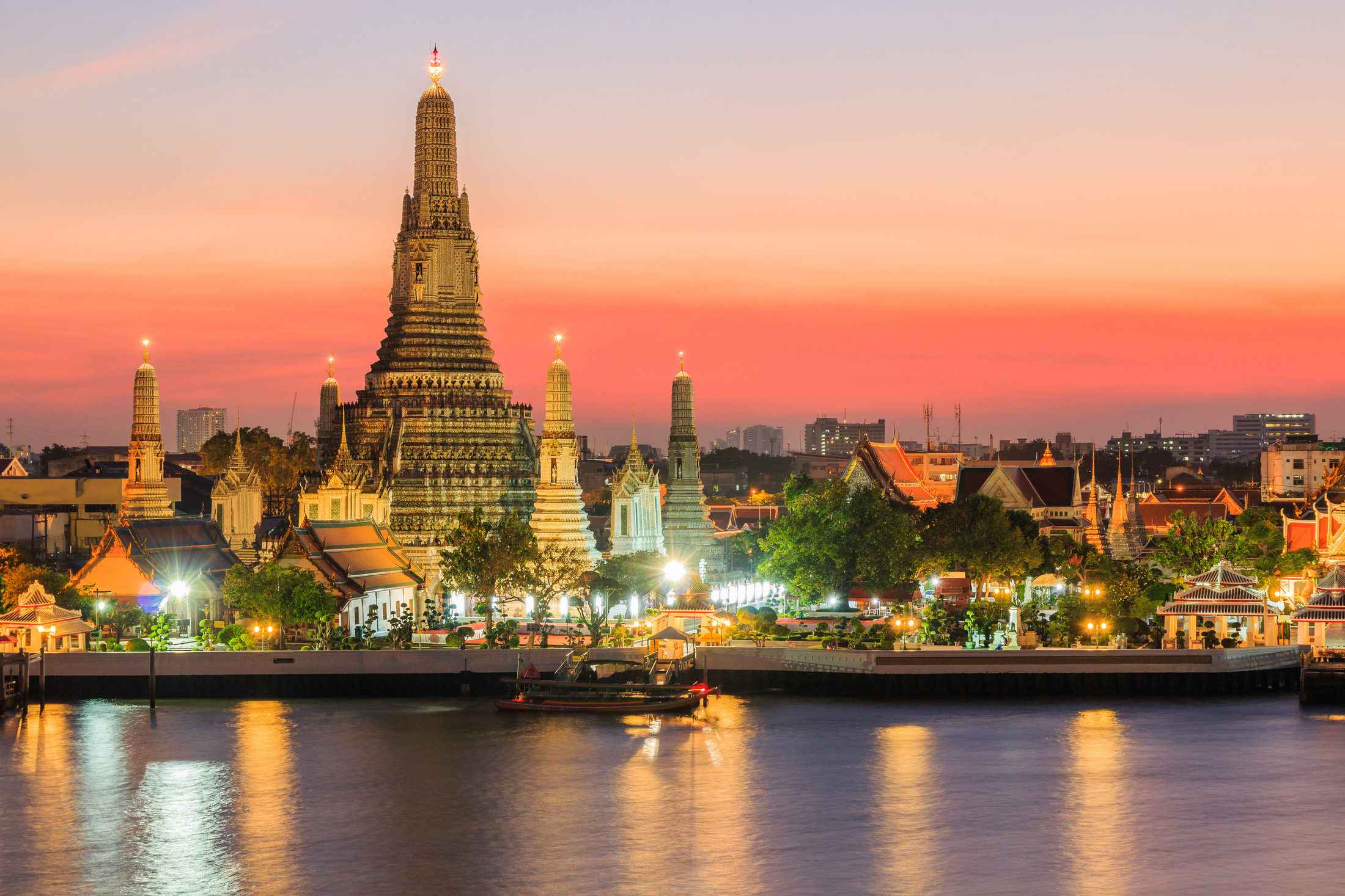 Wat Arun temple beside the Chao Phraya River at sunset